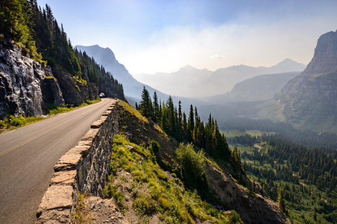 a scenic road winds its way through stunning view of mountains and towering trees